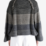 Grey hoodie worn by a person, showing the hoodie fit