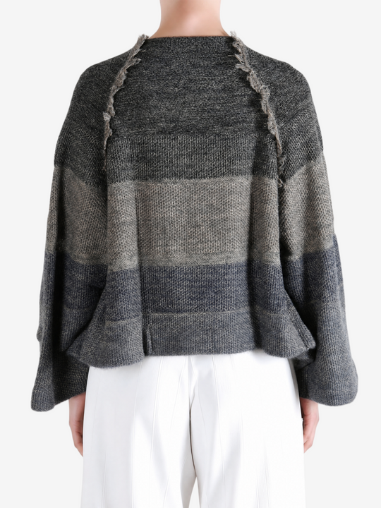 Grey hoodie worn by a person, showing the hoodie fit
