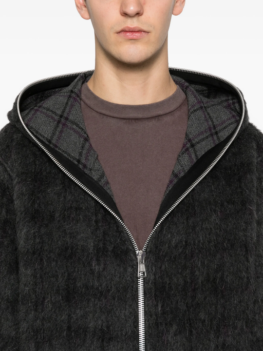 Close up of black hoodie, showing texture of the Wool fabric