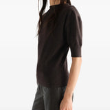 Brown knitwear worn by a person, showing the knitwear fit