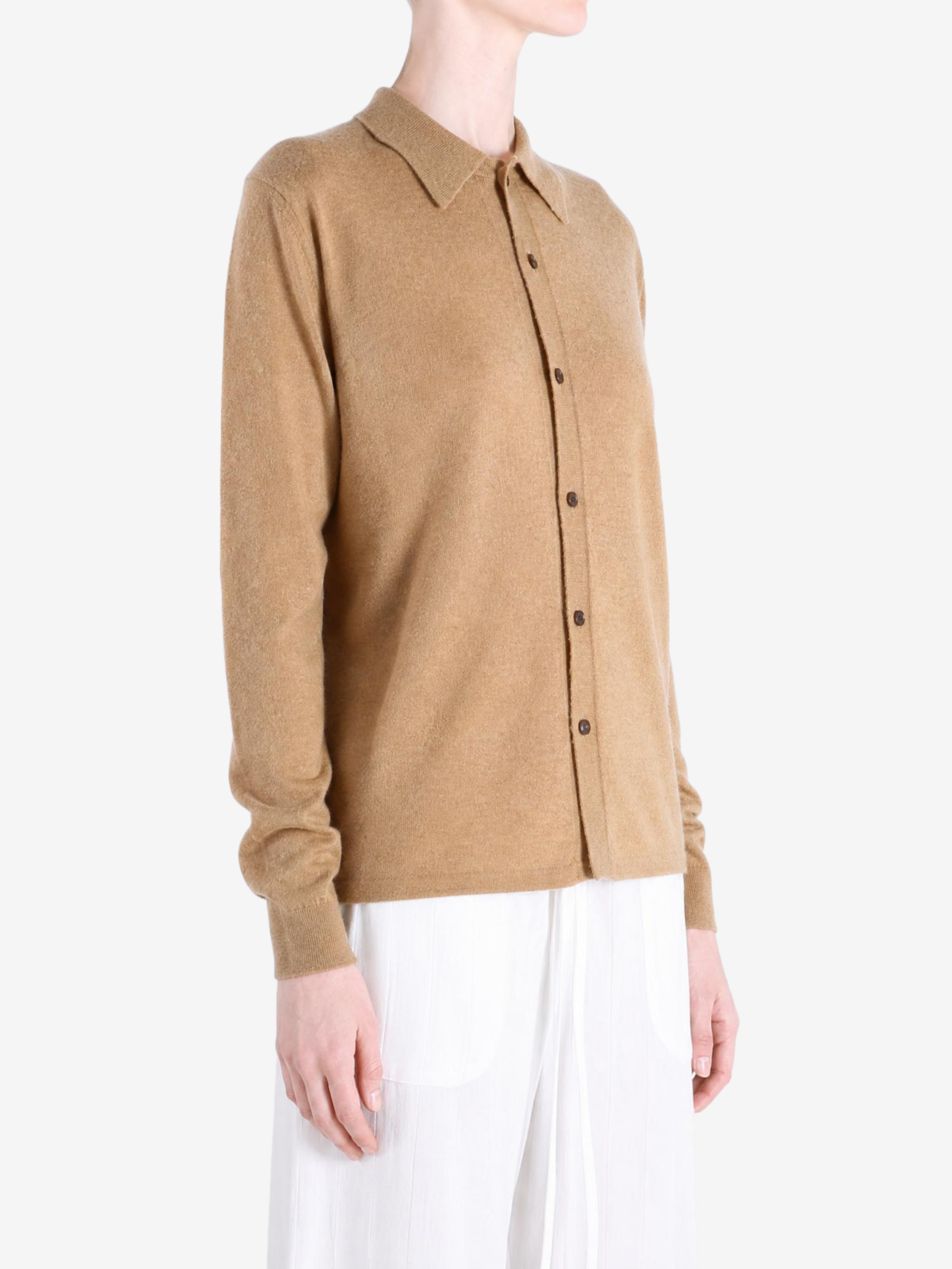 Tan knitwear worn by a person, showing the knitwear fit