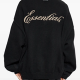 black sweater worn by a person, showing the sweater fit