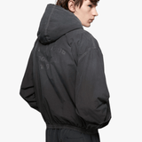 Black jacket worn by a person, showing the jacket fit