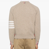 tan knitwear worn by a person, showing the knitwear fit