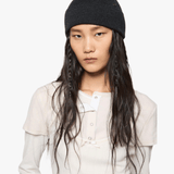 Black hat worn by a person, showing the hat fit