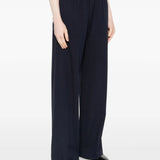 Navy pants worn by a person, showing the pants' fit