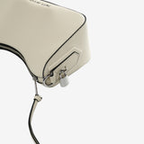Close up of tan bag, showing texture of the split cow leather w fabric