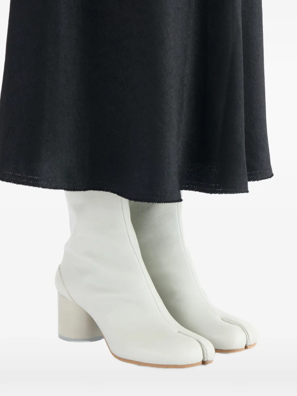 White boots worn by a person, showing the boots fit