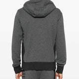 Grey hoodie worn by a person, showing the hoodie's fit
