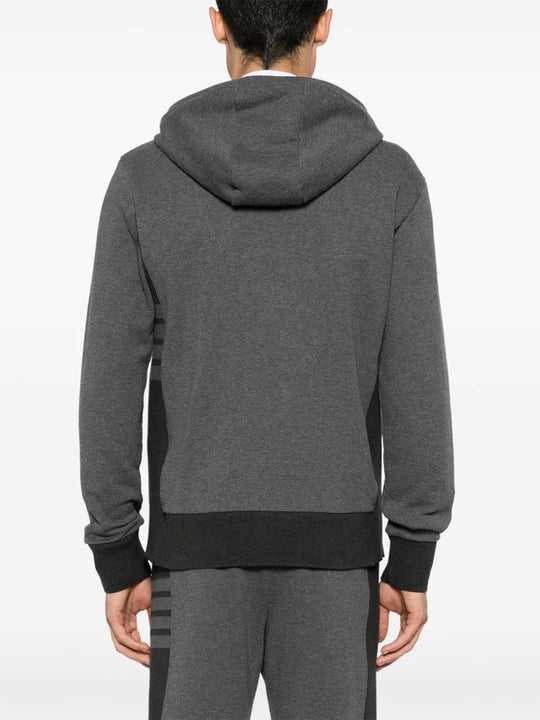 Grey hoodie worn by a person, showing the hoodie's fit