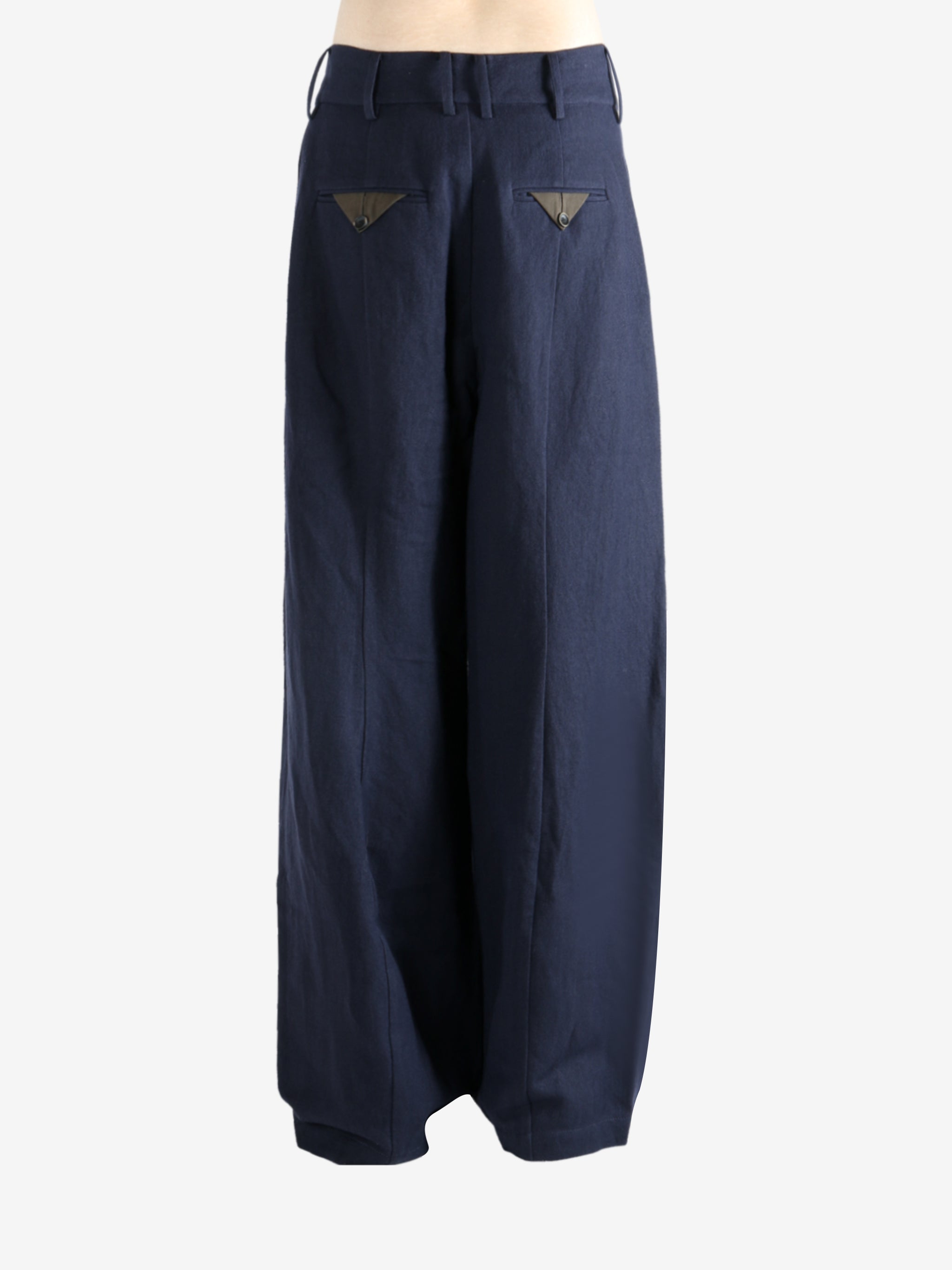 Navy pants worn by a person, showing the pants's fit