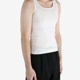 White tank worn by a person, showing the tank fit