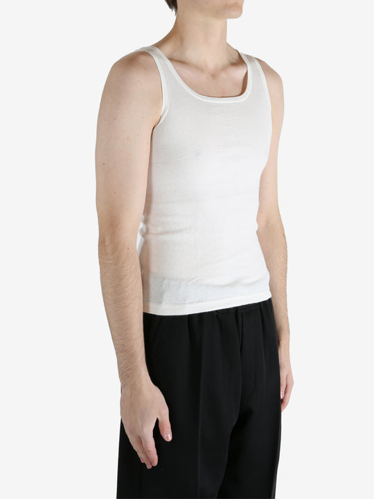 White tank worn by a person, showing the tank fit