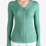 Green top worn by a person, showing the top fit