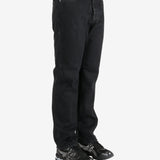 Black pants worn by a person, showing the pants's fit