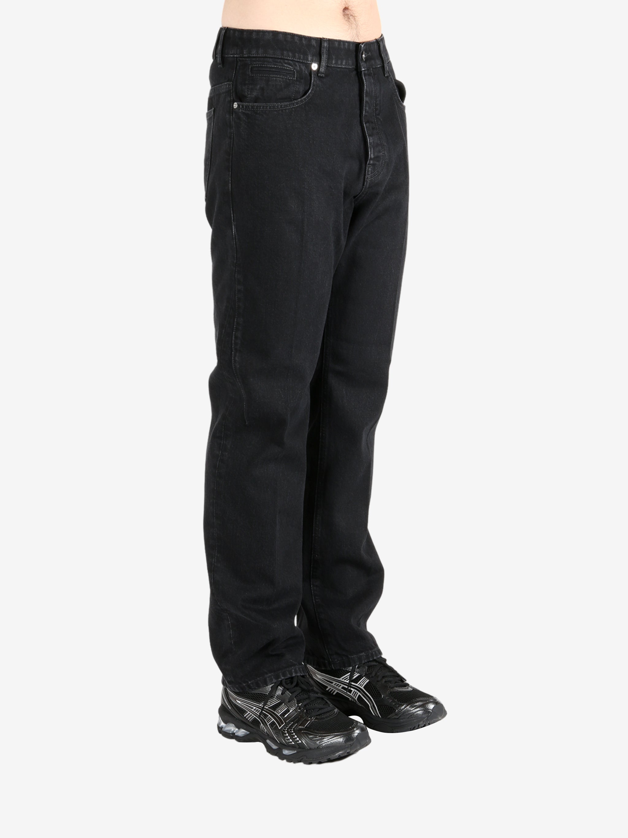 Black pants worn by a person, showing the pants's fit