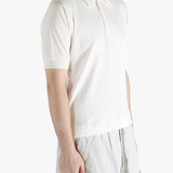 White top worn by a person, showing the top's fit