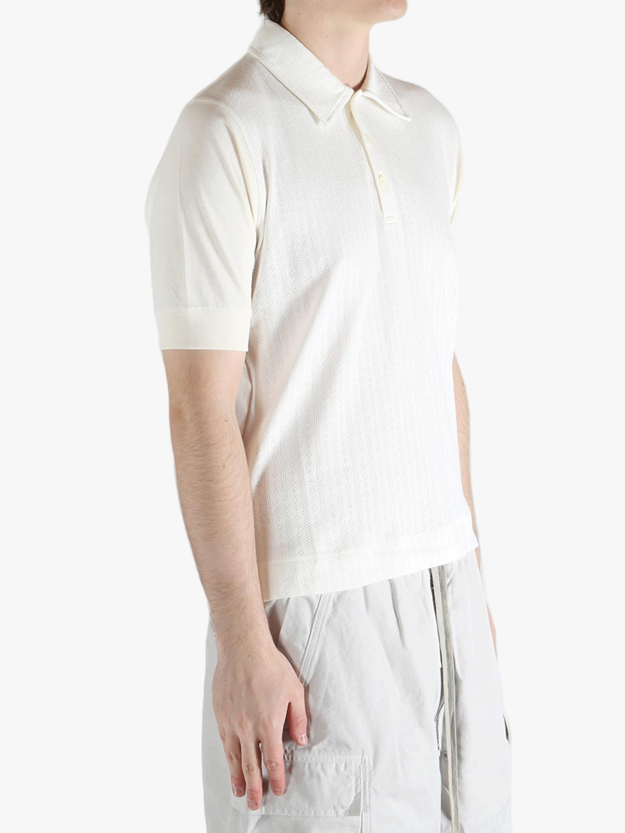 White top worn by a person, showing the top's fit