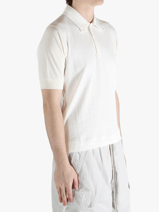 White top worn by a person, showing the top's fit