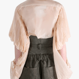 Tan shirt worn by a person, showing the shirt's fit