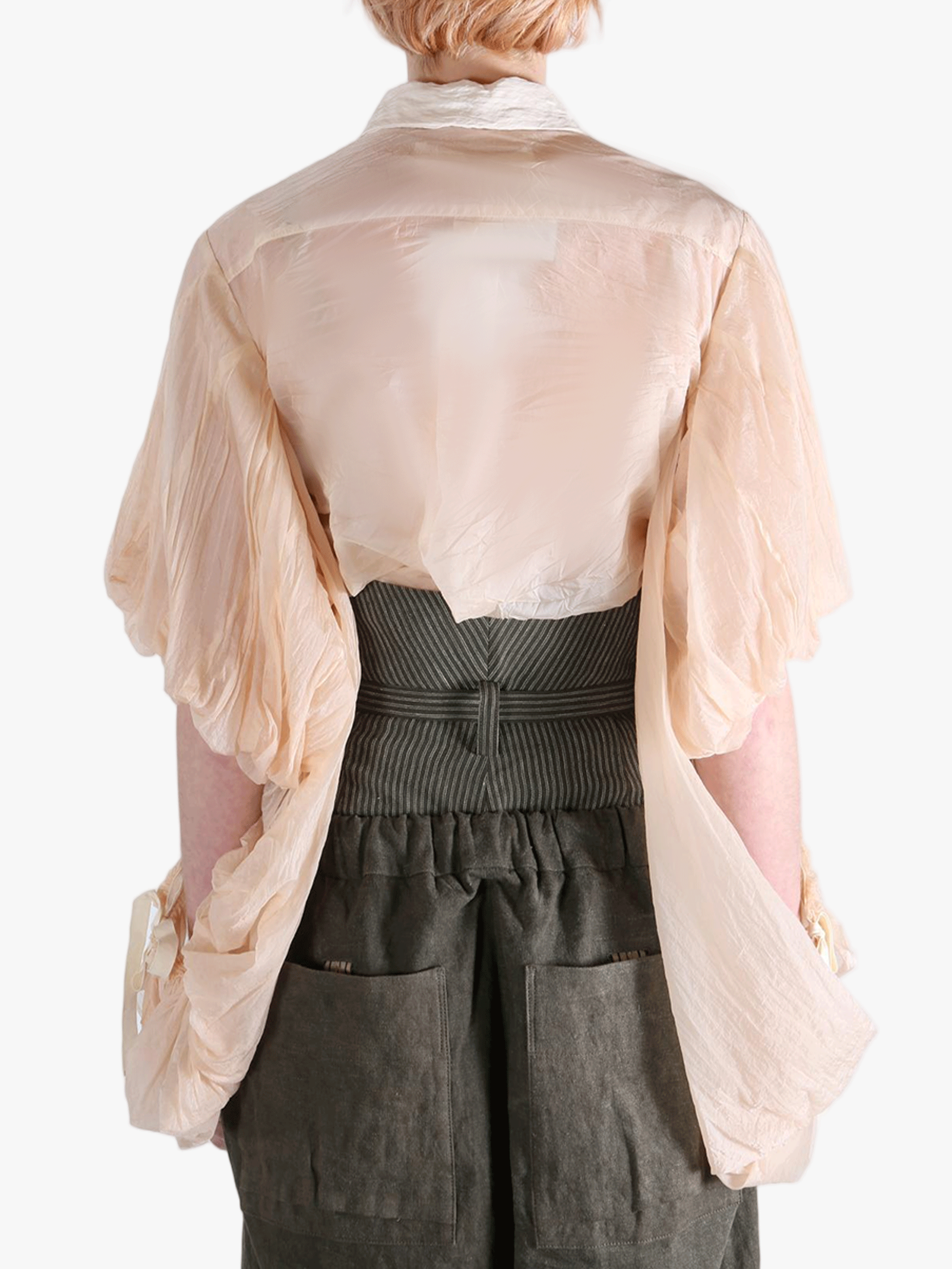 Tan shirt worn by a person, showing the shirt's fit