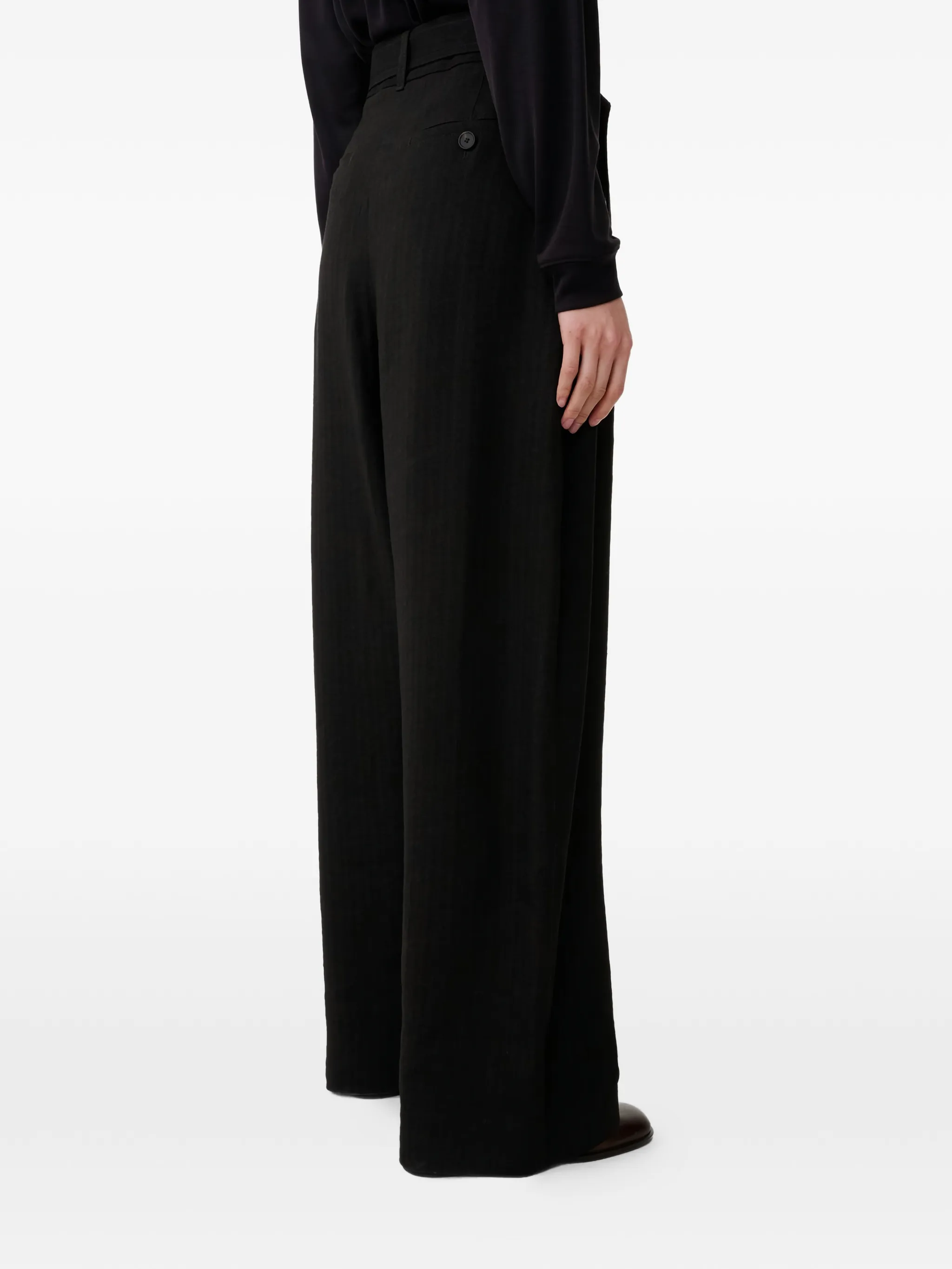 Brown pants worn by a person, showing the pants fit