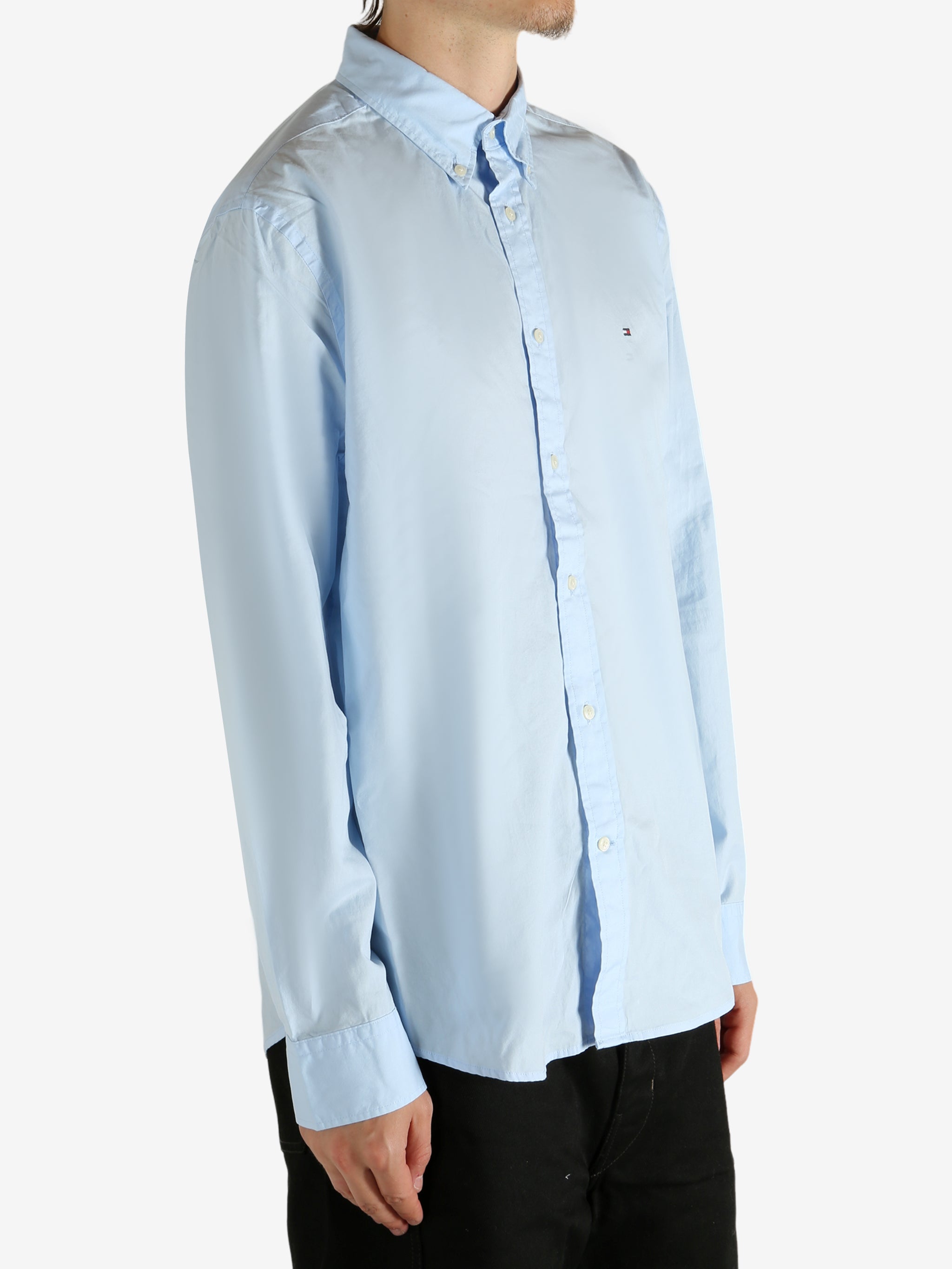 Blue shirt worn by a person, showing the shirt's fit