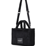 Close up of black bag, showing texture of the Adjustable detachable shoulder strap