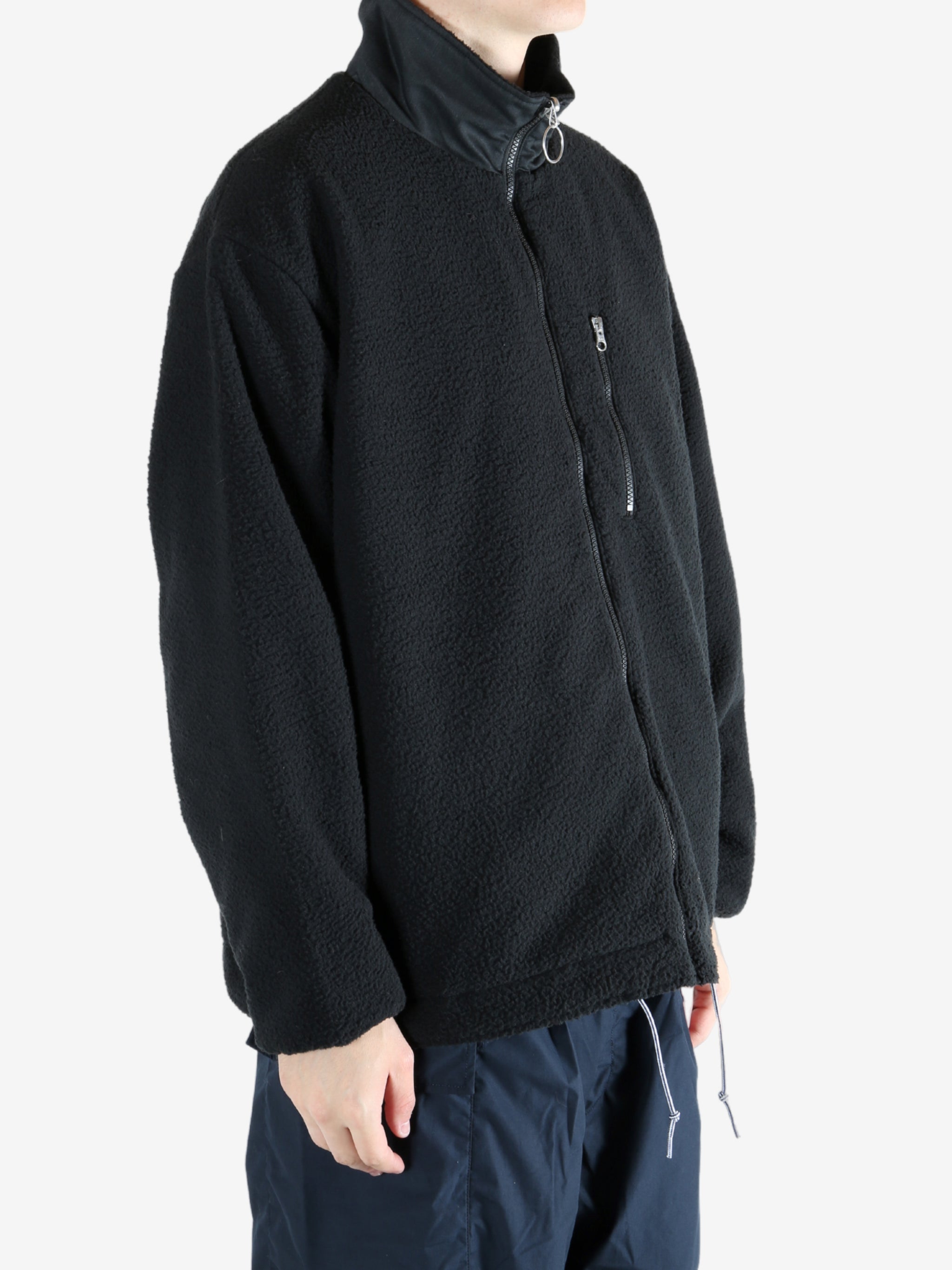 Black jacket worn by a person, showing the jacket's fit