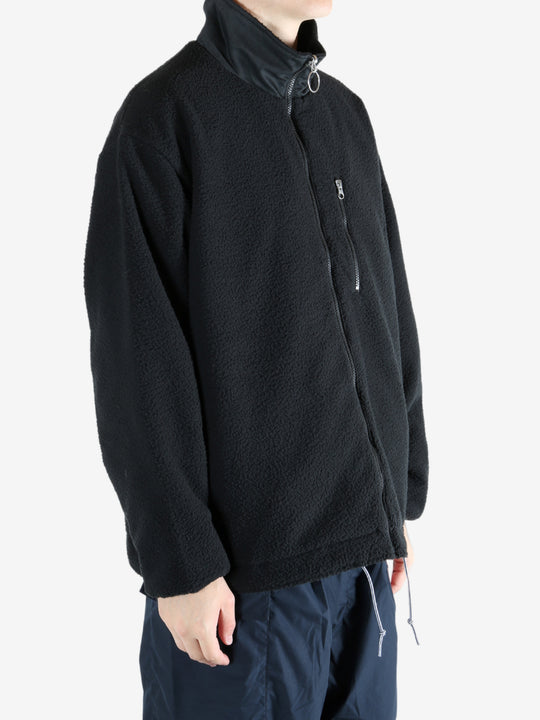 Black jacket worn by a person, showing the jacket's fit