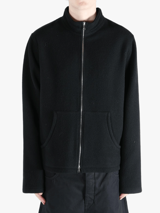 Black jacket worn by a person, showing the jacket's fit