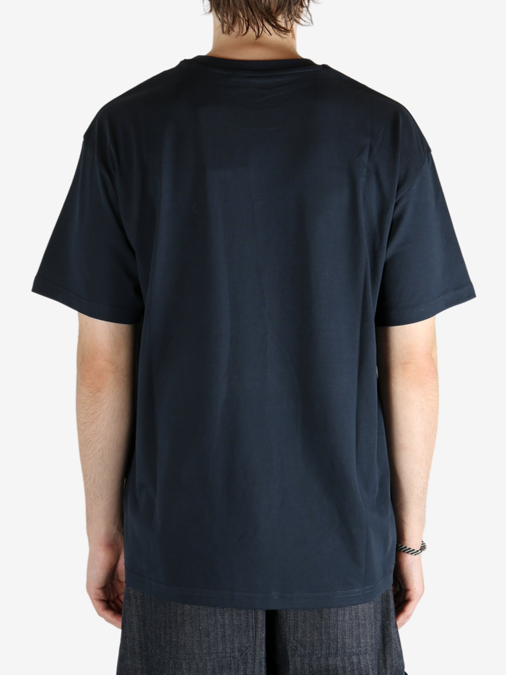 Blue t-shirt worn by a person, showing the shirt fit