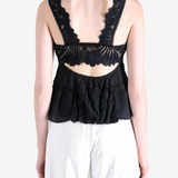 Black top worn by a person, showing the top fit