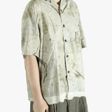 Green shirt worn by a person, showing the shirt's fit