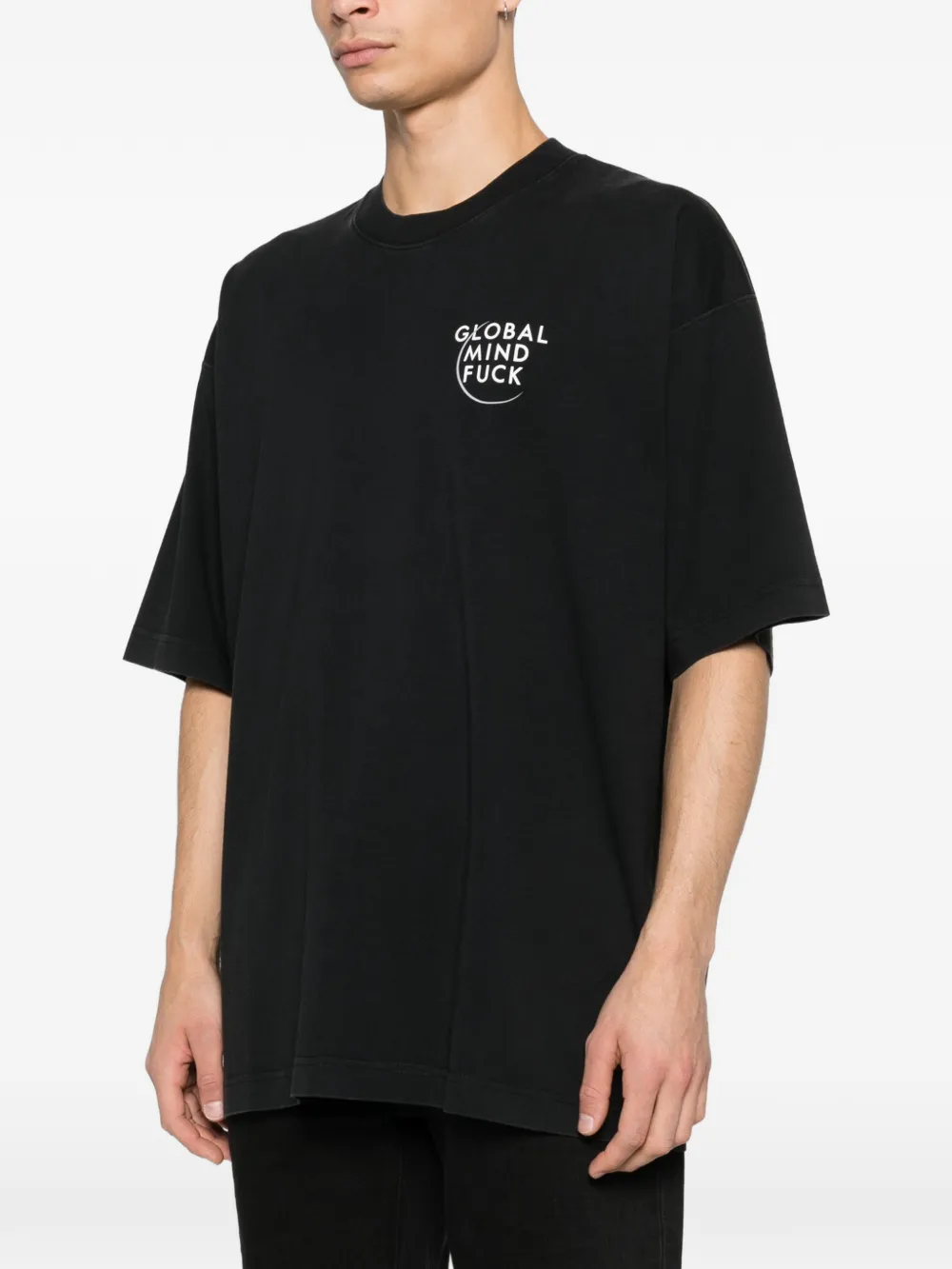 black t-shirt worn by a person, showing the t-shirt fit