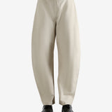 White pants worn by a person, showing the pants' fit