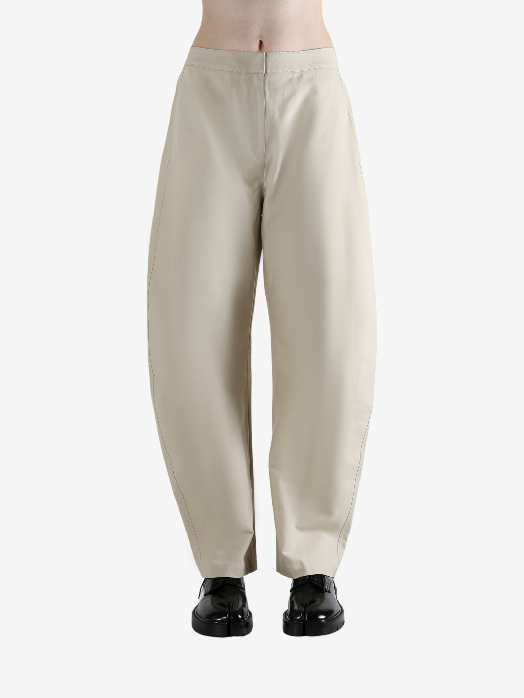 White pants worn by a person, showing the pants' fit