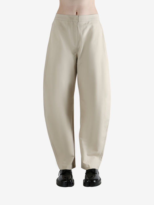 White pants worn by a person, showing the pants' fit