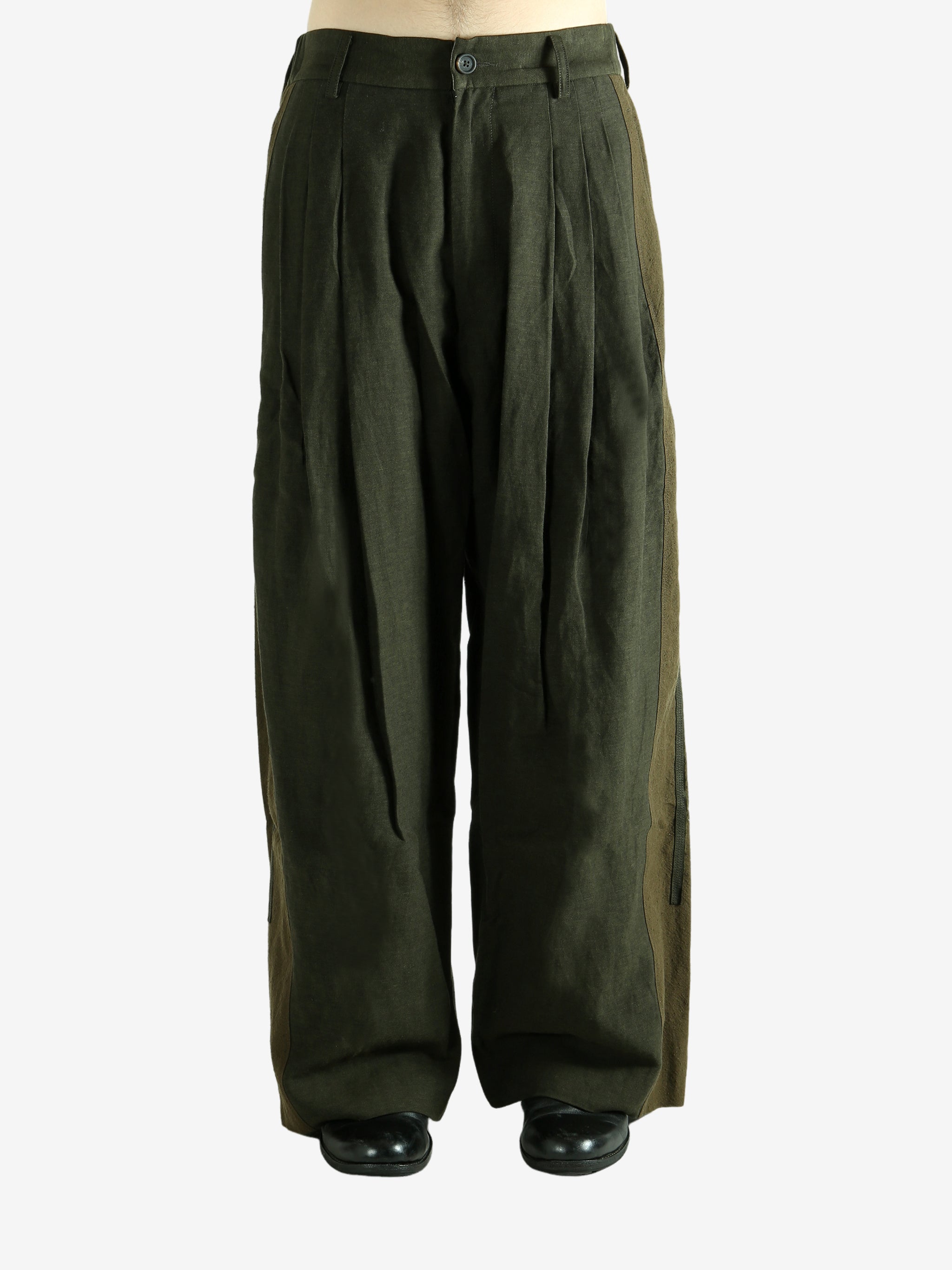 Green pants worn by a person, showing the pants'fit