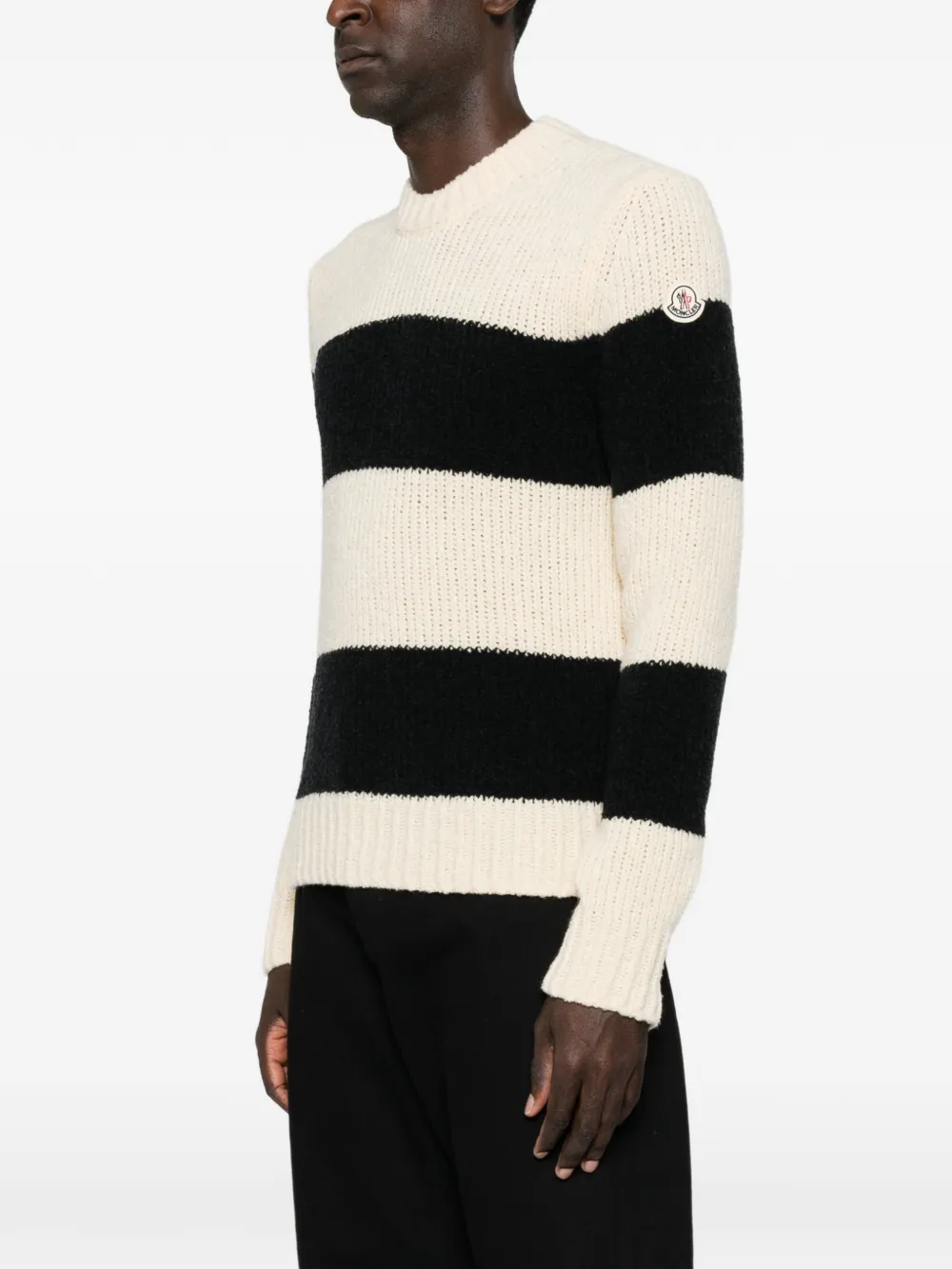 Black knitwear worn by a person, showing the knitwear fit