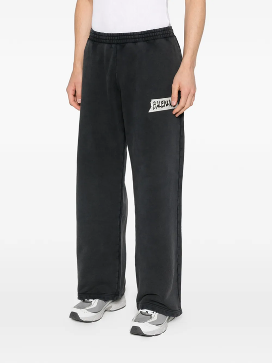 black pants worn by a person, showing the pants fit