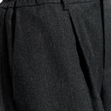 Close-up of black pants, showing texture of the wool fabric