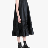 Black dress worn by a person, showing the dress's fit