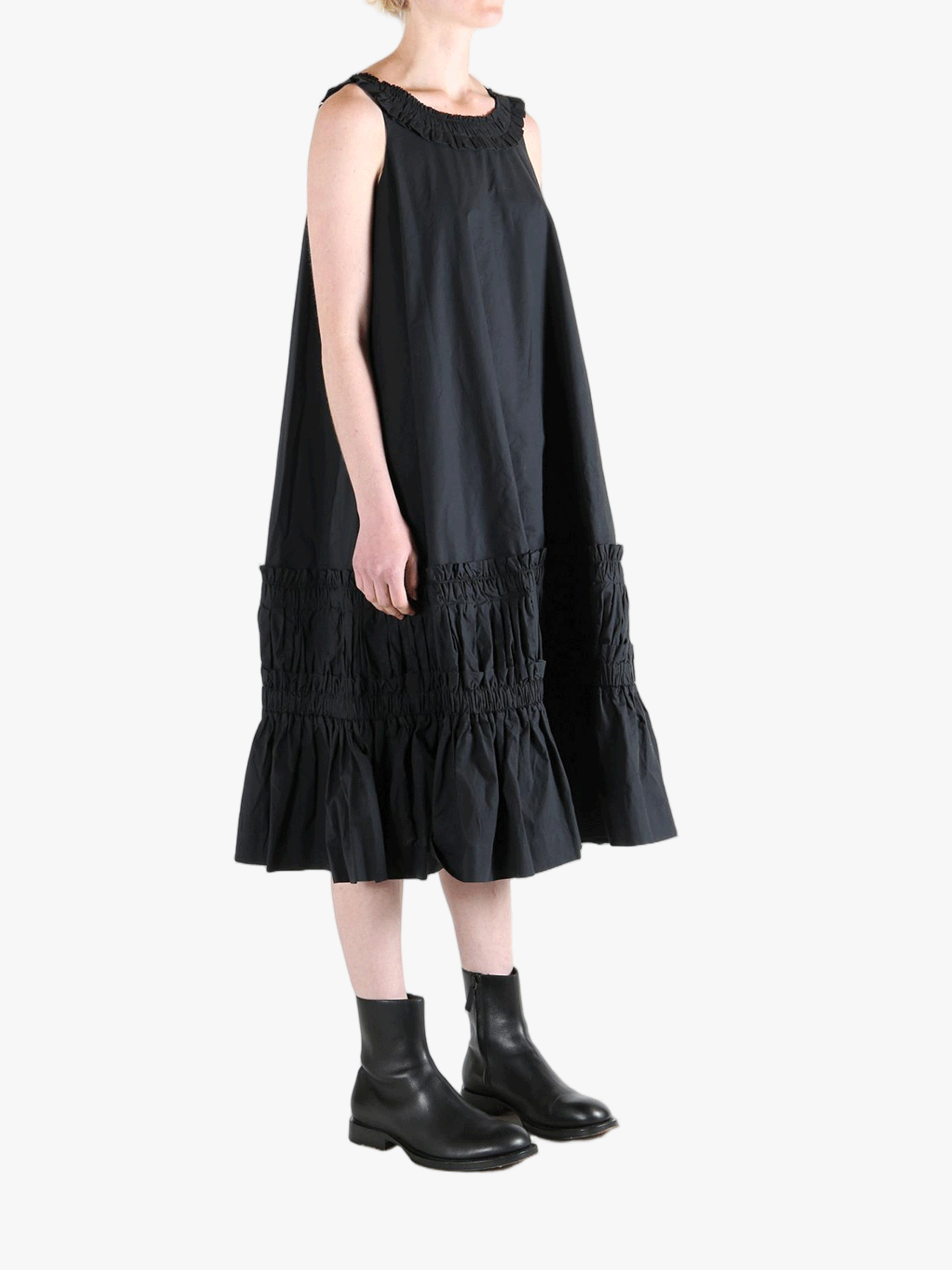 Black dress worn by a person, showing the dress's fit