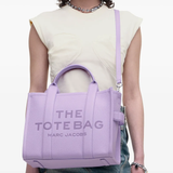 Purple bag worn by a person, showing the bag's fit