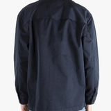 Navy shirts worn by a person, showing the shirts fit