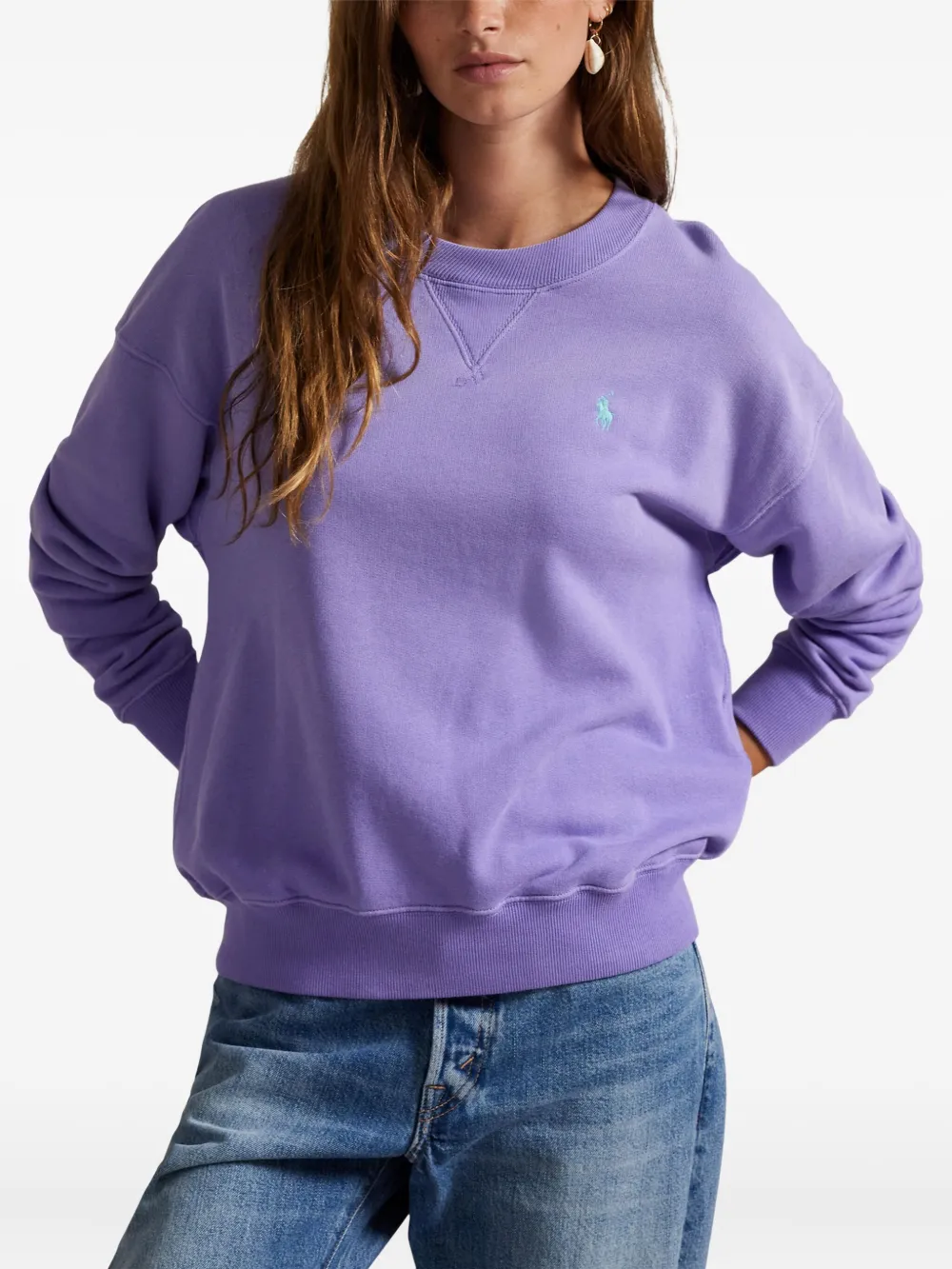 Purple sweatshirt worn by a person, showing the sweatshirt's fit