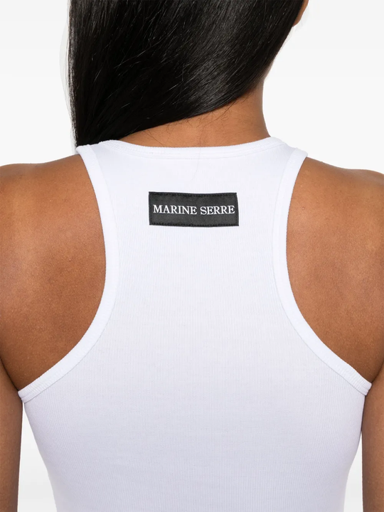 Close up of white top, showing texture of the orangic cotton fabric