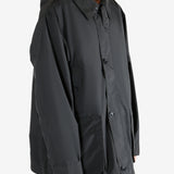 Black jacket worn by a person, showing the jacket's fit