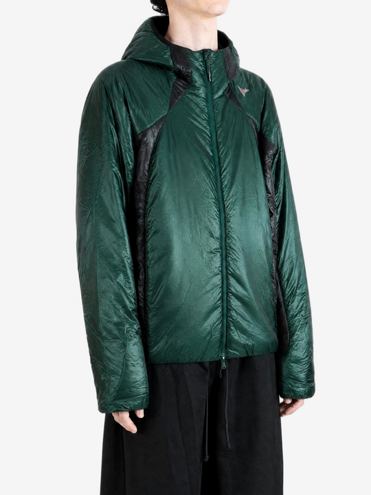 Green jacket worn by a person, showing the jacket fit